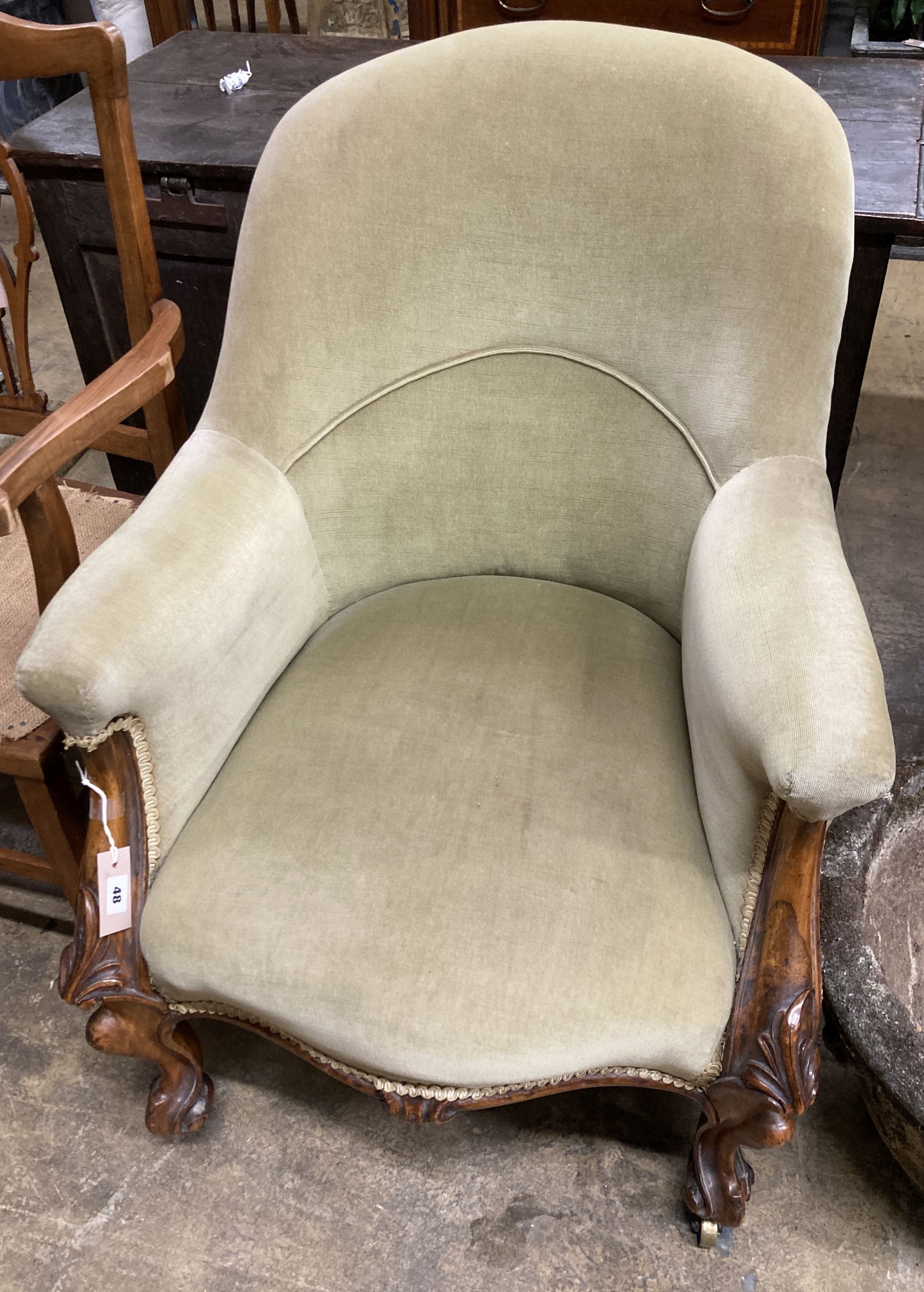 A Victorian walnut spoon back armchair, width 66cm, depth 84cm, height 84cm